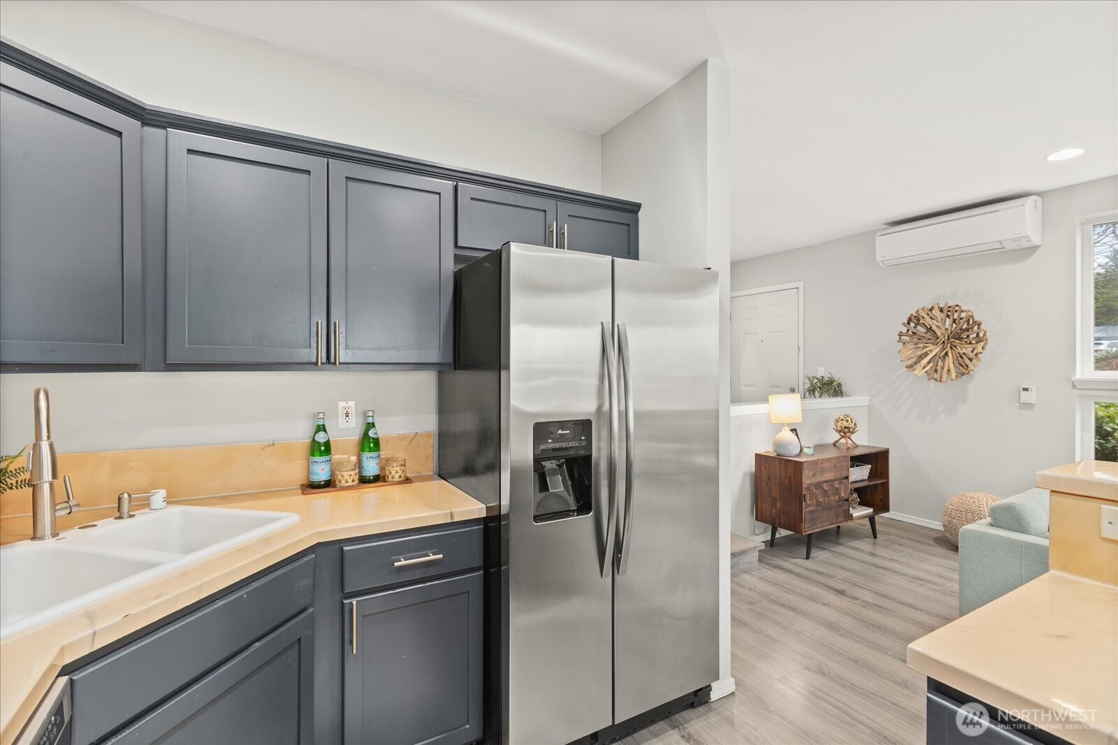 2325 Harbor Avenue Southwest, Unit B1 Seattle, WA 98126 - Photo 16 of 37 a kitchen with stainless steel appliances a refrigerator sink and wooden cabinets