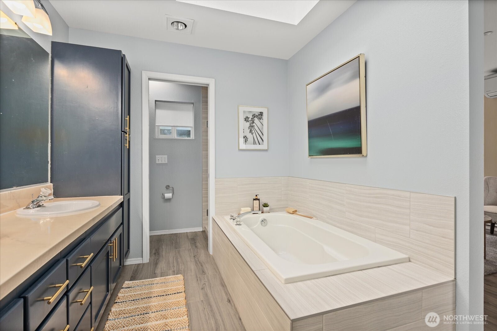 2325 Harbor Avenue Southwest, Unit B1 Seattle, WA 98126 - Photo 29 of 37 a bathroom with a sink a mirror and a bathtub