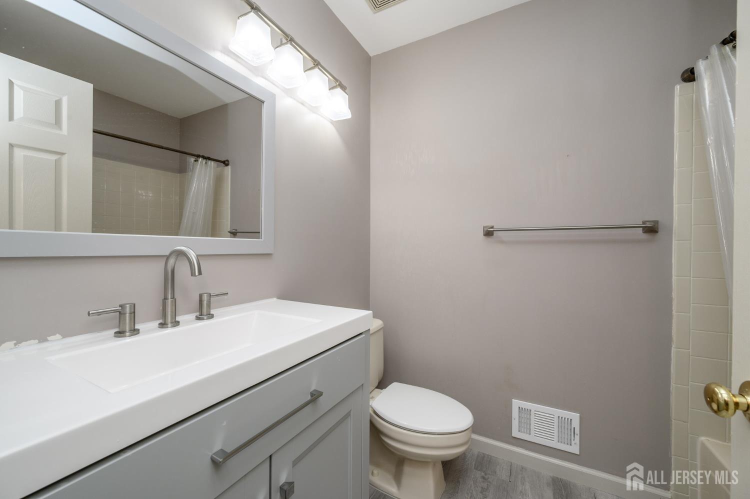 1907 Stech Drive Bridgewater, NJ 08807 - Photo 23 of 55 a bathroom with a sink mirror vanity and toilet