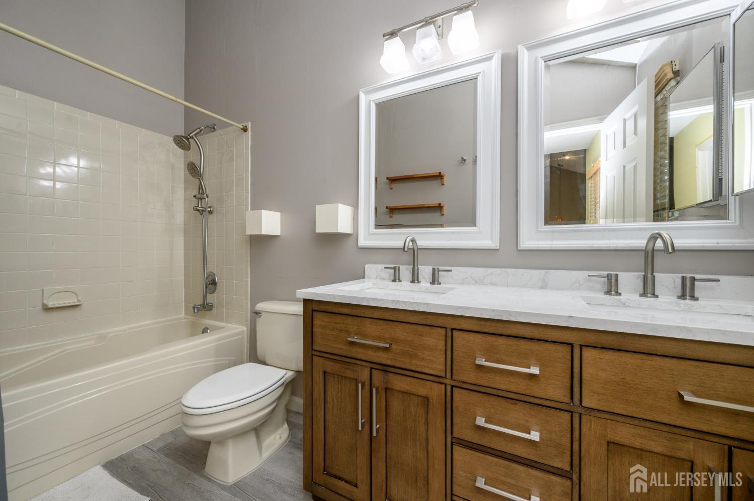1907 Stech Drive Bridgewater, NJ 08807 - Photo 30 of 55 a bathroom with a toilet a sink a mirror a bathtub and vanity