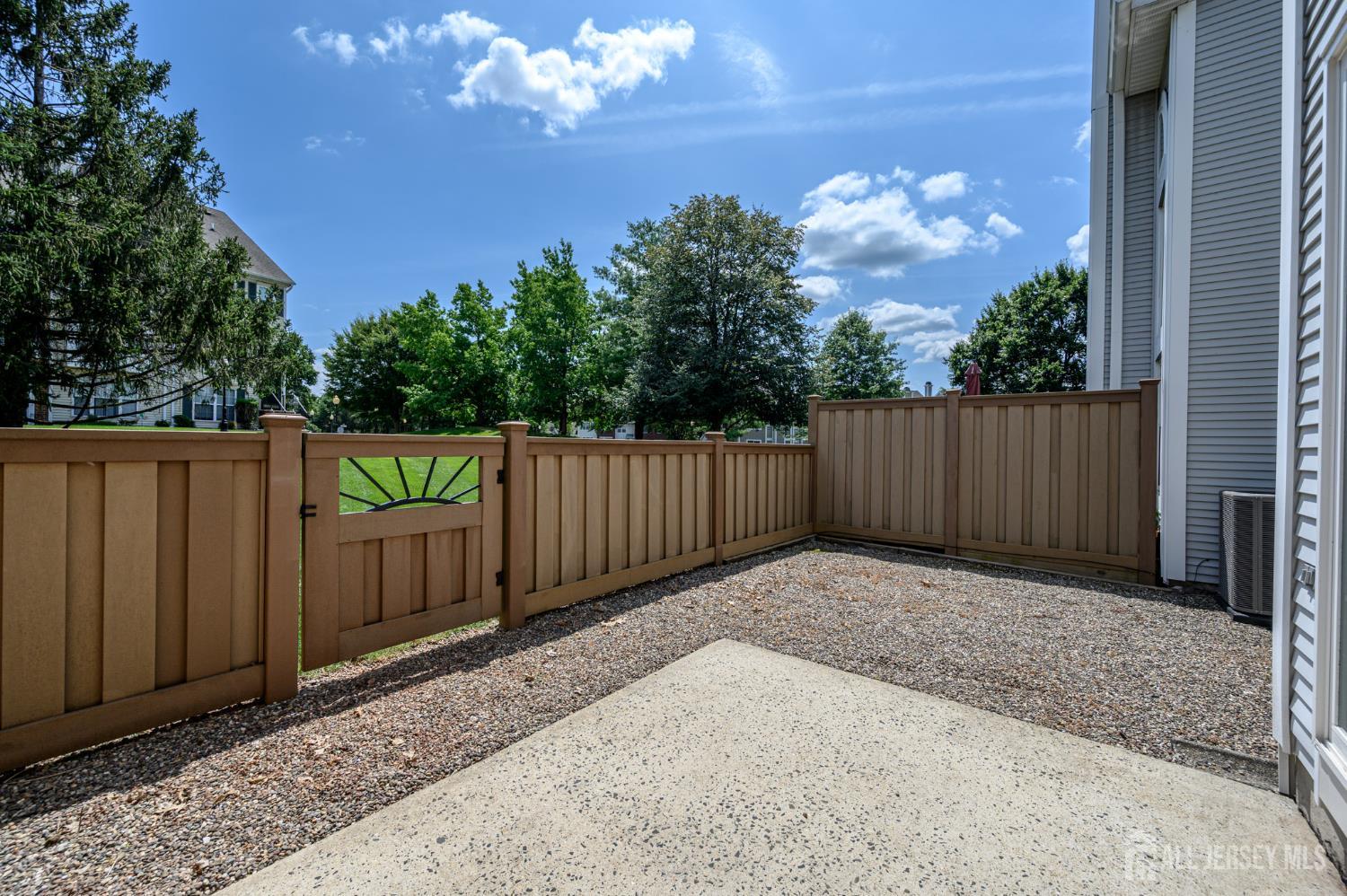 1907 Stech Drive Bridgewater, NJ 08807 - Photo 45 of 55 a view of backyard with wooden fence and trees in the background