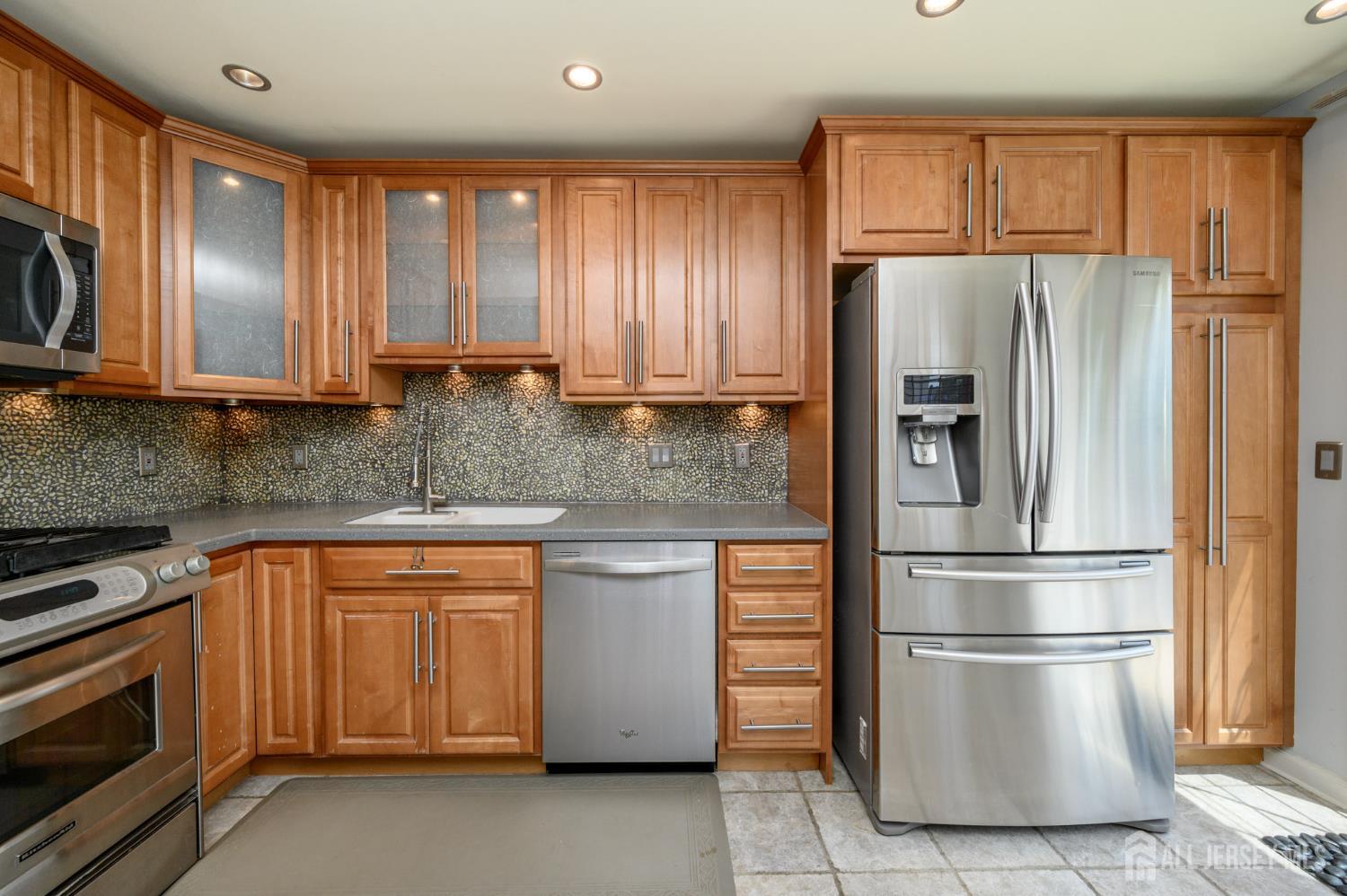 1907 Stech Drive Bridgewater, NJ 08807 - Photo 5 of 55 a kitchen with stainless steel appliances granite countertop a refrigerator sink and stove