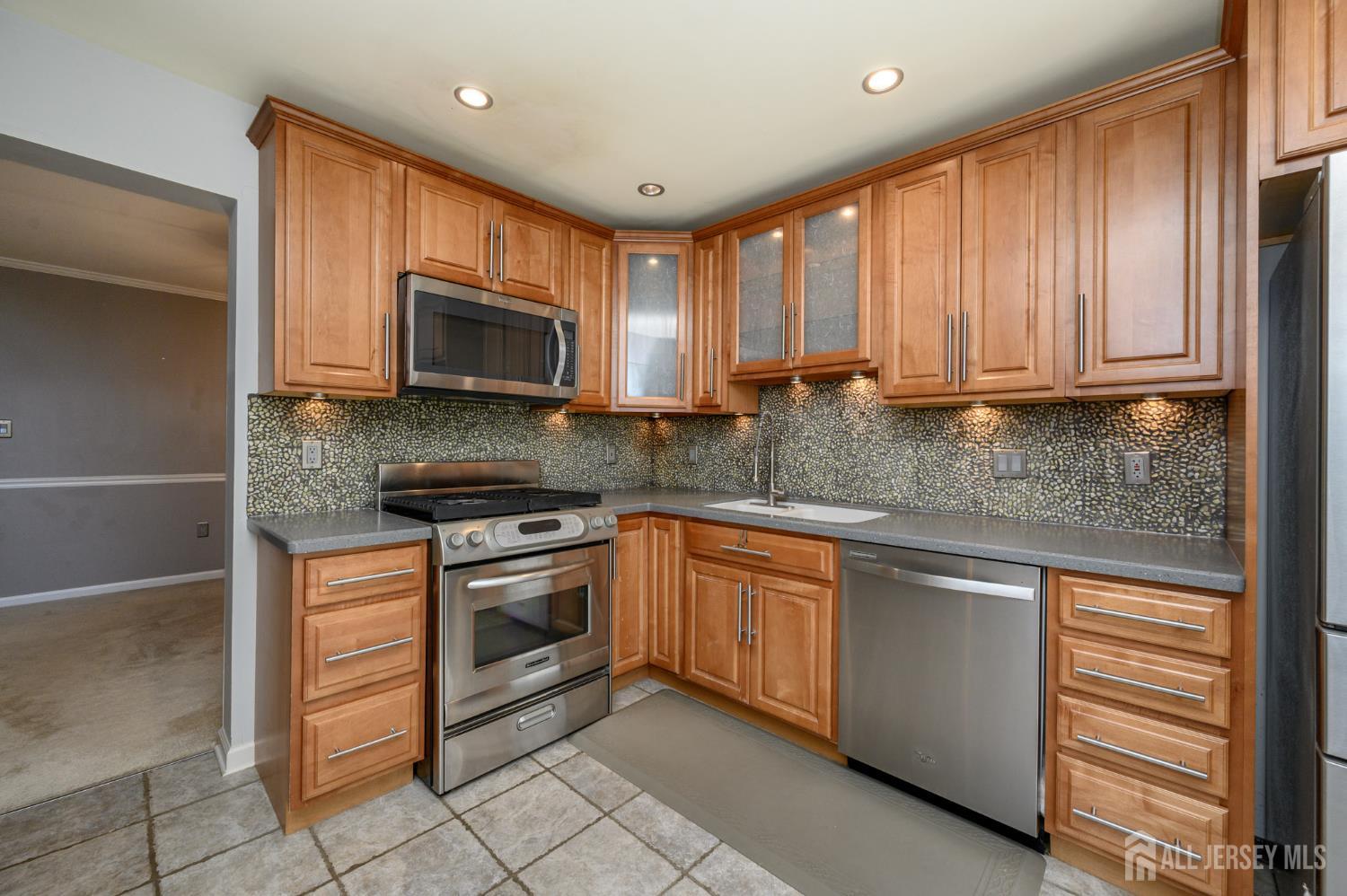 1907 Stech Drive Bridgewater, NJ 08807 - Photo 6 of 55 a kitchen with stainless steel appliances granite countertop a stove microwave and cabinets
