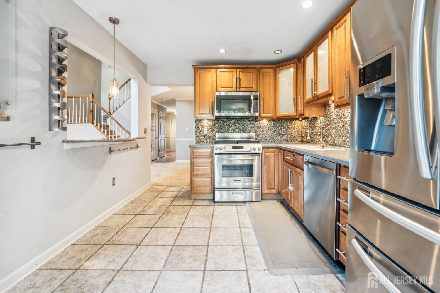 1907 Stech Drive Bridgewater, NJ 08807 - Photo 7 of 55 a kitchen with stainless steel appliances granite countertop a stove top oven a sink a counter space and cabinets