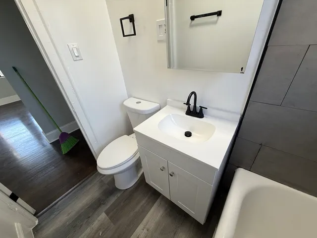 a white toilet sitting next to a bathroom sink