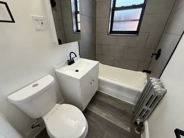 a white toilet sitting next to a bathroom sink
