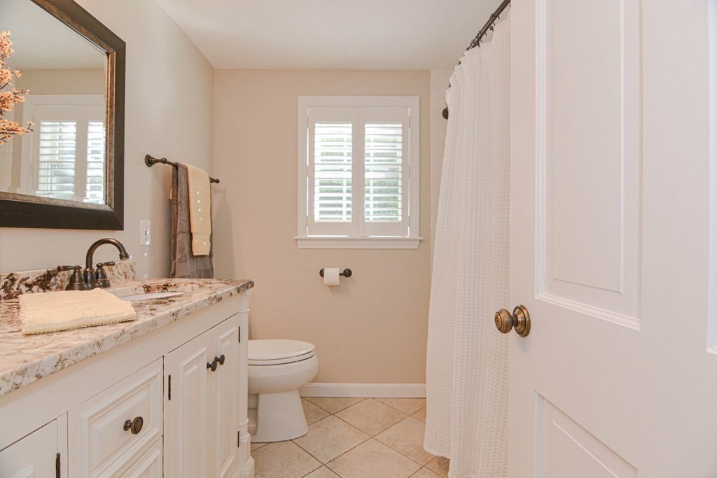 520 Burroughs Road Boxborough, MA 01719 - Photo 16 of 34 a bathroom with a granite countertop sink toilet and shower