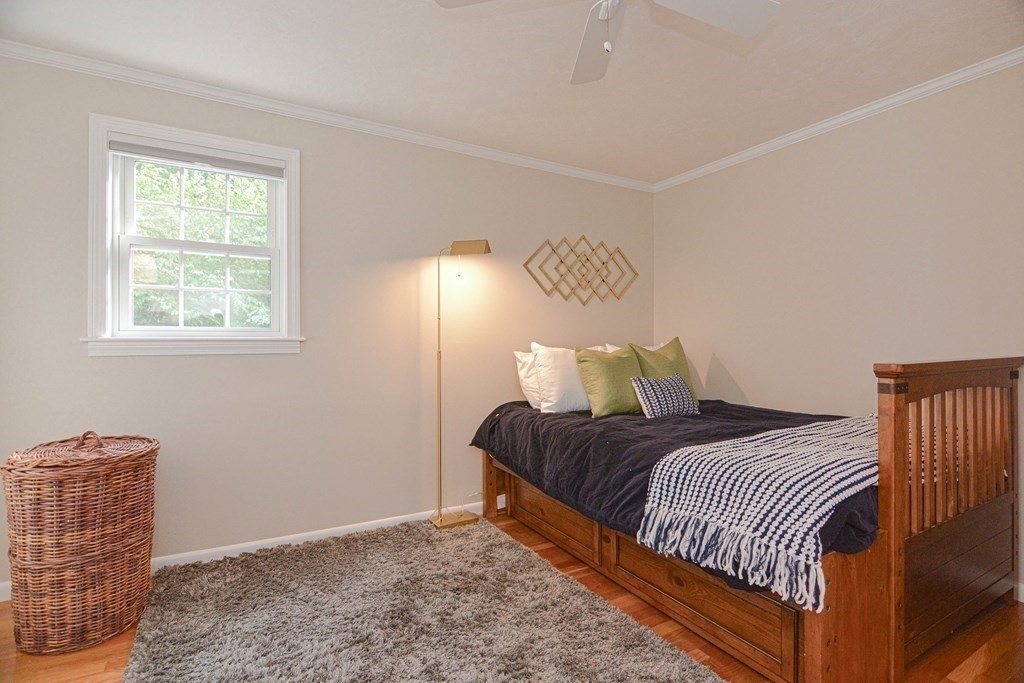 520 Burroughs Road Boxborough, MA 01719 - Photo 20 of 34 a bedroom with a bed and wooden floor