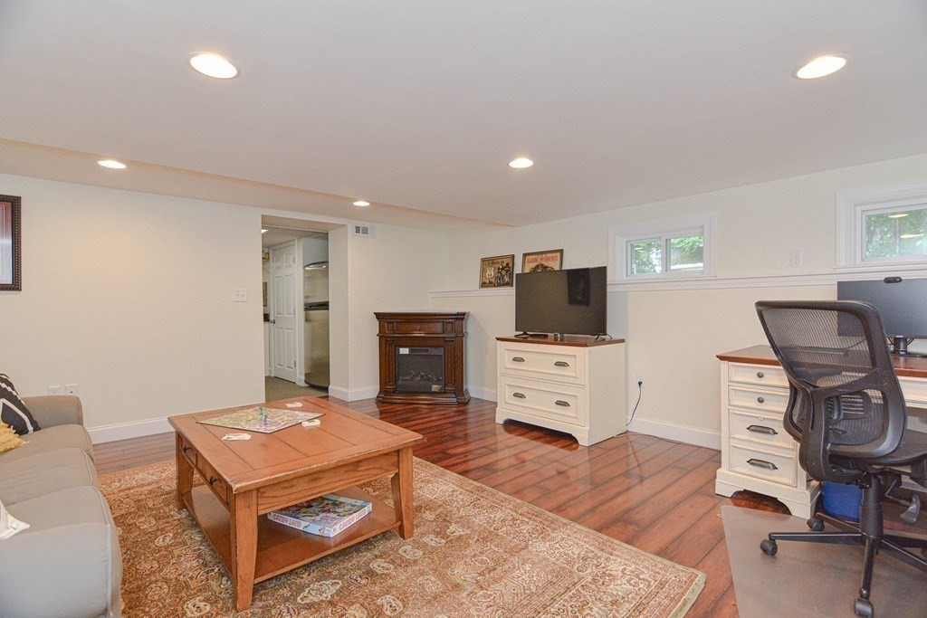 520 Burroughs Road Boxborough, MA 01719 - Photo 22 of 34 a living room with furniture and a flat screen tv