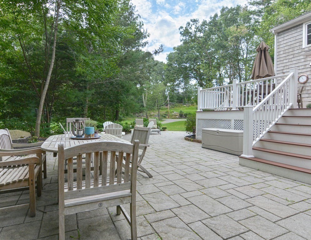 520 Burroughs Road Boxborough, MA 01719 - Photo 24 of 34 a view of a patio with table and chairs with wooden floor and fence