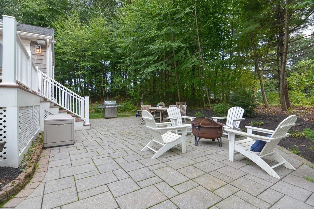 520 Burroughs Road Boxborough, MA 01719 - Photo 25 of 34 a view of a patio with a dining table and chairs with wooden fence and floor