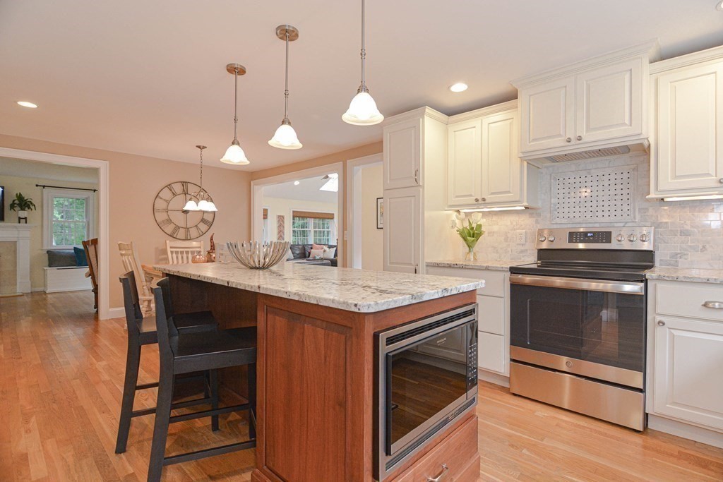 520 Burroughs Road Boxborough, MA 01719 - Photo 4 of 34 a kitchen with a stove and a wooden floor