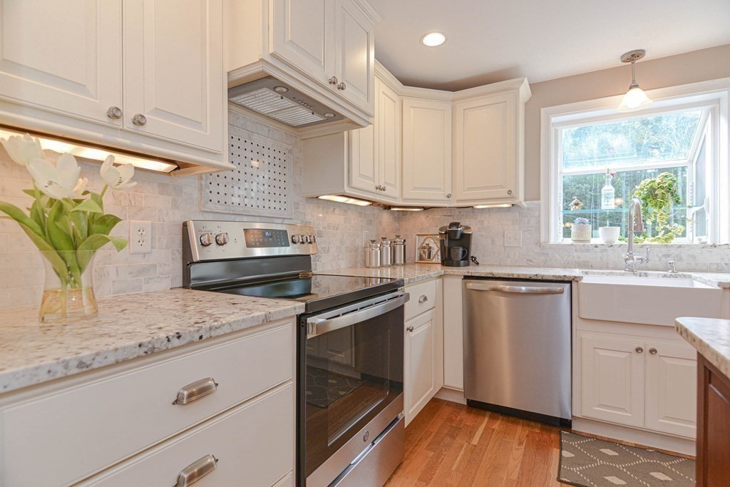 520 Burroughs Road Boxborough, MA 01719 - Photo 5 of 34 a kitchen with granite countertop white cabinets and white appliances