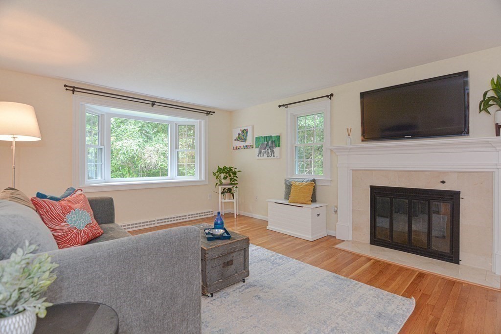 520 Burroughs Road Boxborough, MA 01719 - Photo 9 of 34 a living room with furniture a flat screen tv and a fireplace