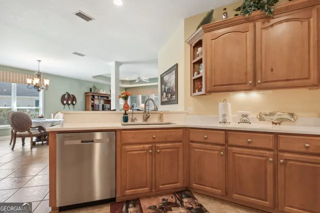 a kitchen with cabinets and chairs