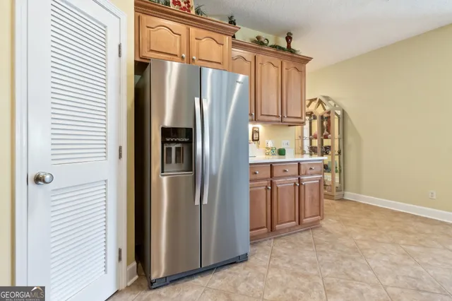 a kitchen with stainless steel appliances granite countertop a refrigerator and a stove