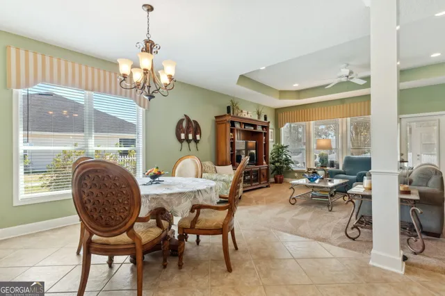 a view of a livingroom with furniture window and a chandelier