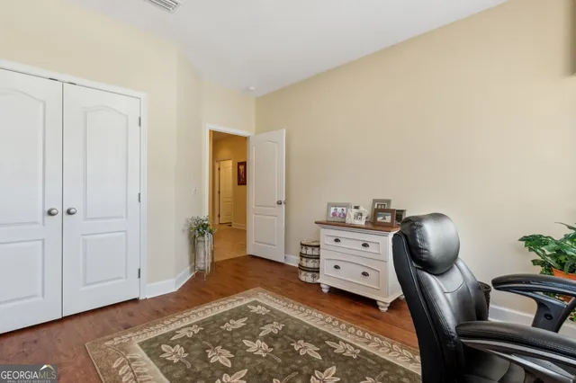 a bedroom with a chair and a chair