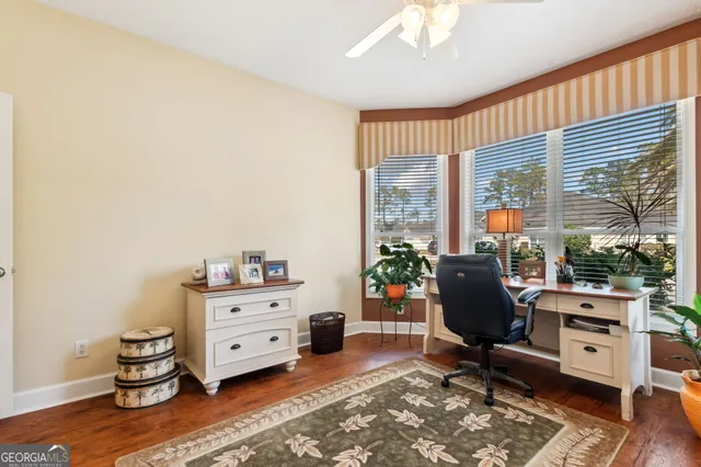 a view of a workspace with furniture and a window