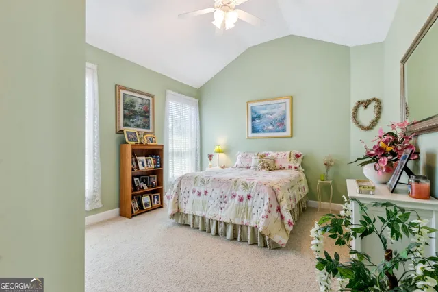 a spacious bedroom with a bed a wall painting and a window