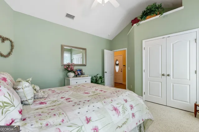 a bedroom with a bed and a mirror