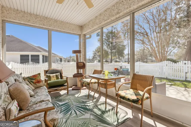 a living room with furniture and a floor to ceiling window