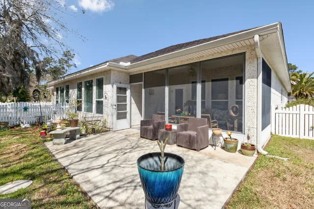 a view of a patio with couches chairs and potted plants