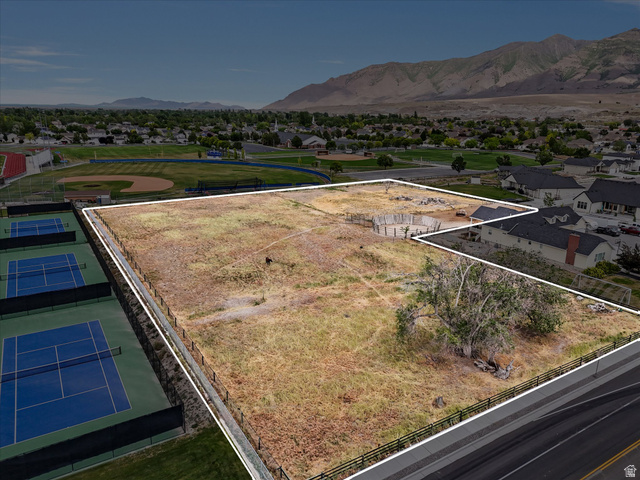 149 Bates Canyon Road Stansbury Park, UT 84074 - Photo 3 of 9 Expansive undeveloped lot featuring partial foundation work, perimeter fencing, mature trees, and direct road frontage
