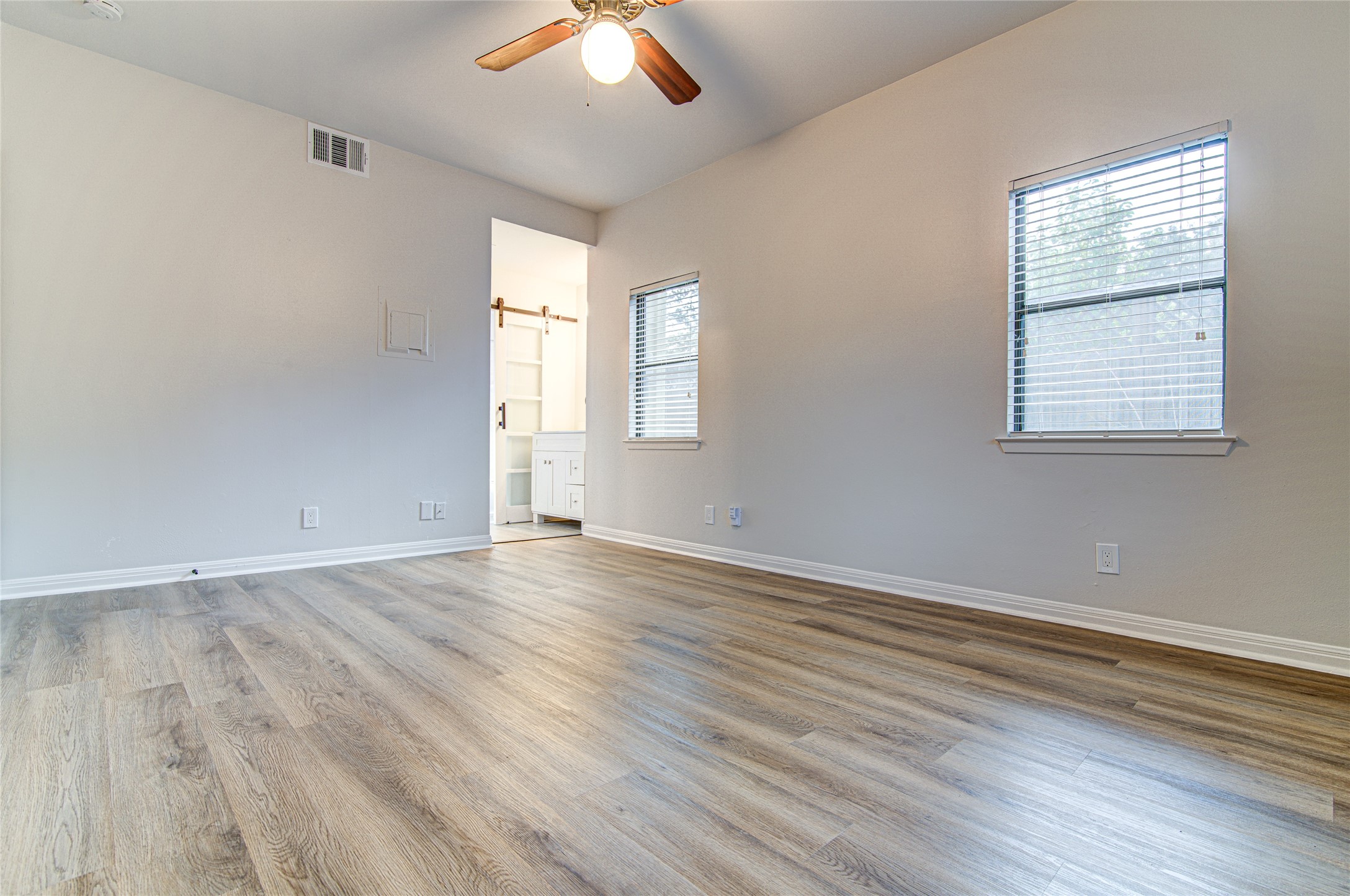 311 West Mary Street Austin, TX 78704 - Photo 35 of 35 An open floor plan master bedroom with high ceilings and beautiful wood flooring.