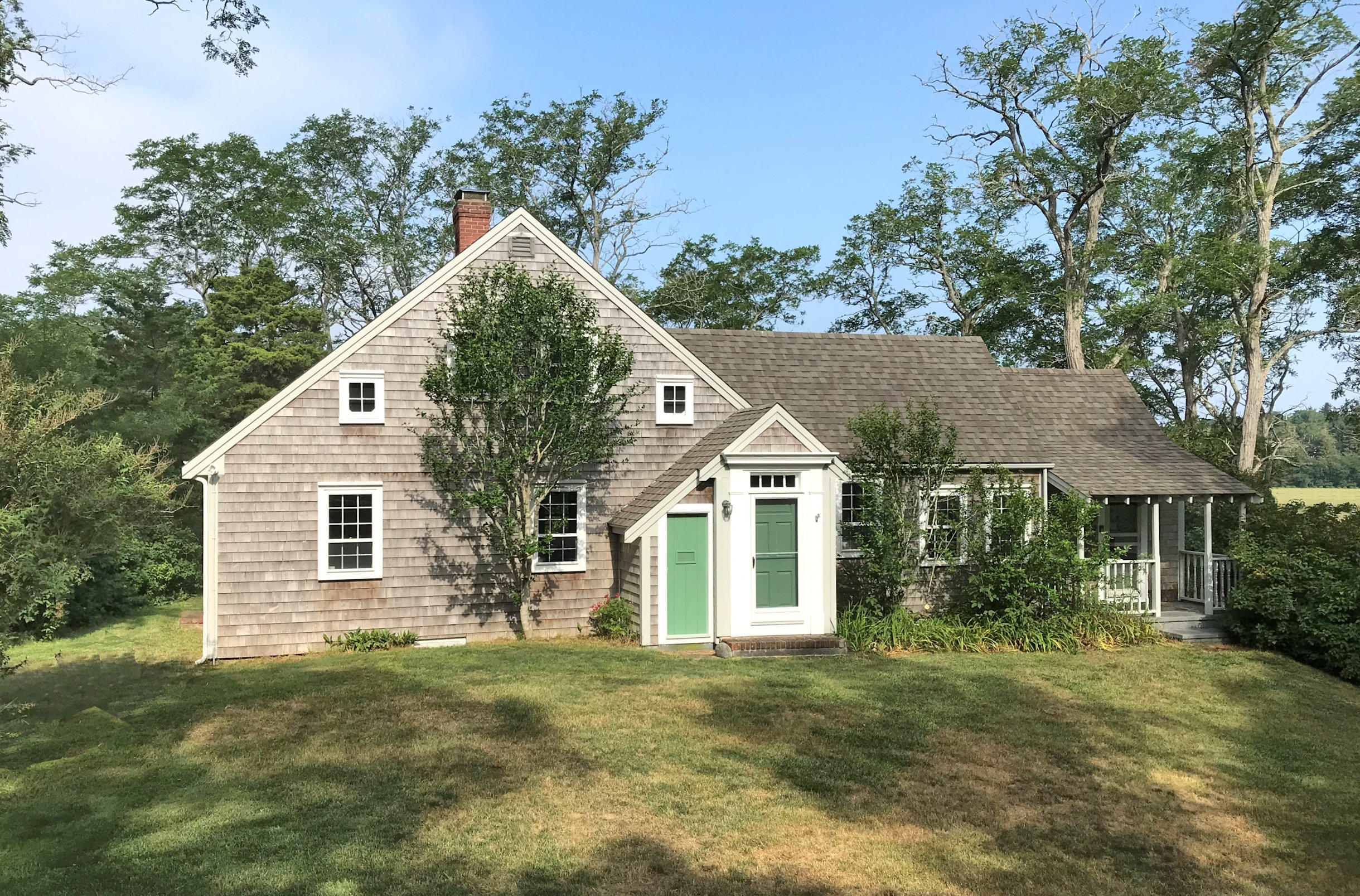 a view of a house with a yard and plants