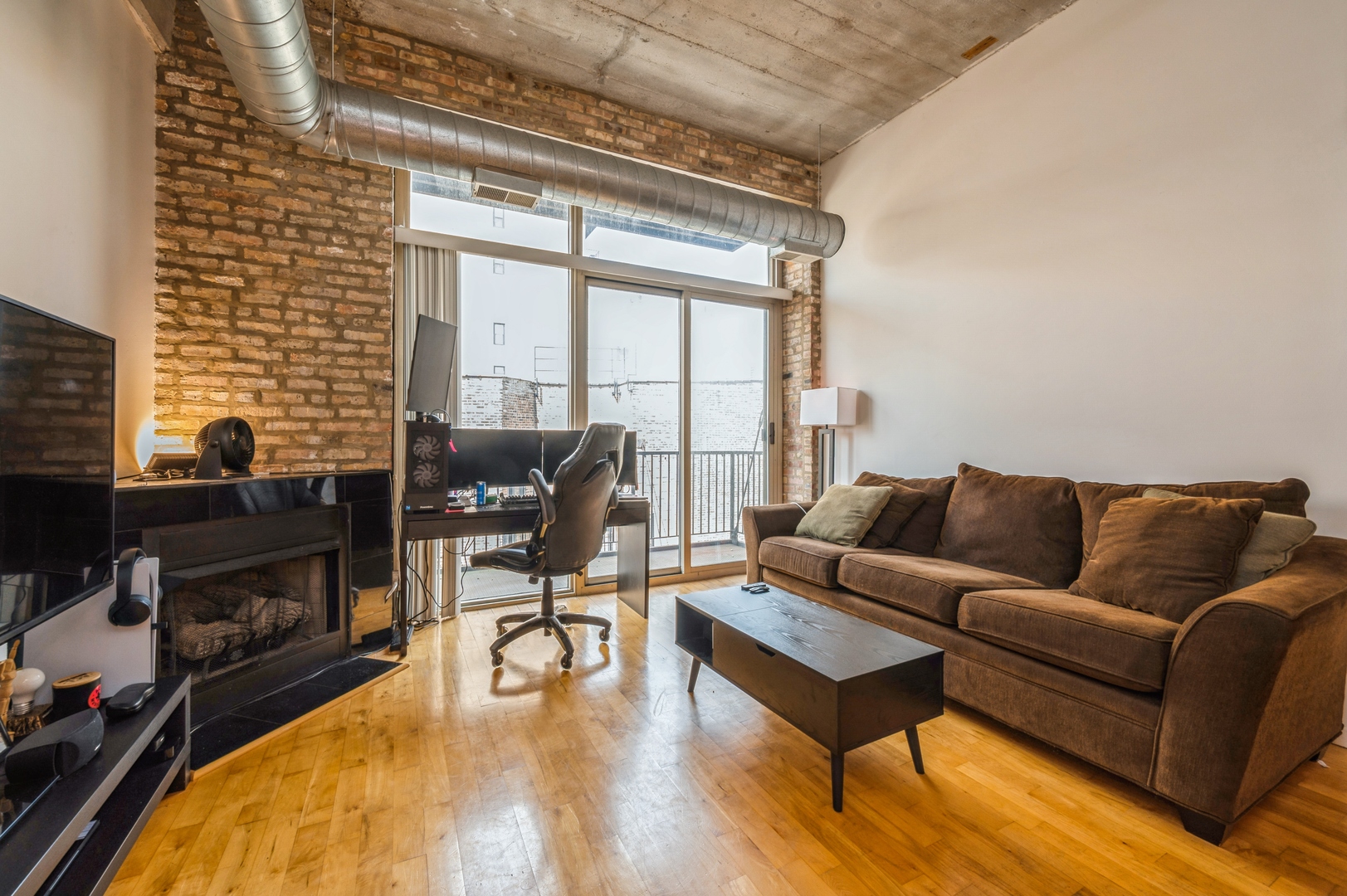 1528 South Wabash Avenue, Unit 405 Chicago, IL 60605 - Photo 2 of 10 a living room with furniture and a fireplace