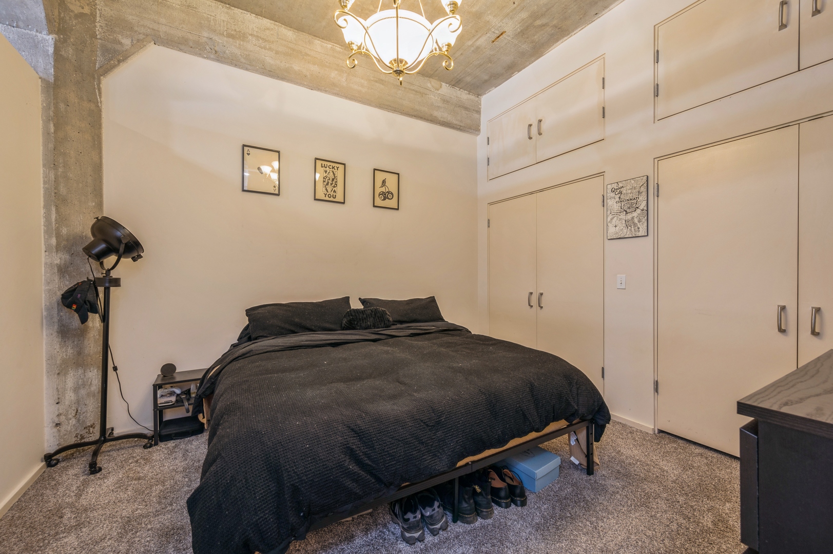 1528 South Wabash Avenue, Unit 405 Chicago, IL 60605 - Photo 6 of 10 a bedroom with a bed and a chandelier
