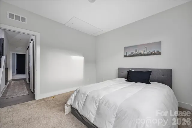 a bedroom with a bed and a painting