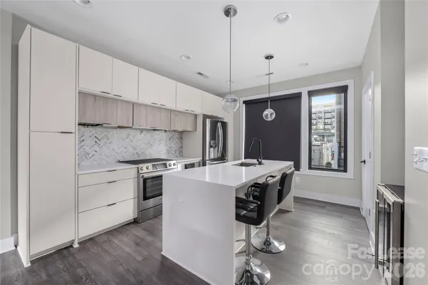 a kitchen with stainless steel appliances granite countertop a stove oven and a refrigerator