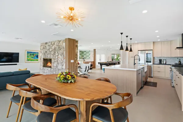 a view of a dining room with furniture and a chandelier