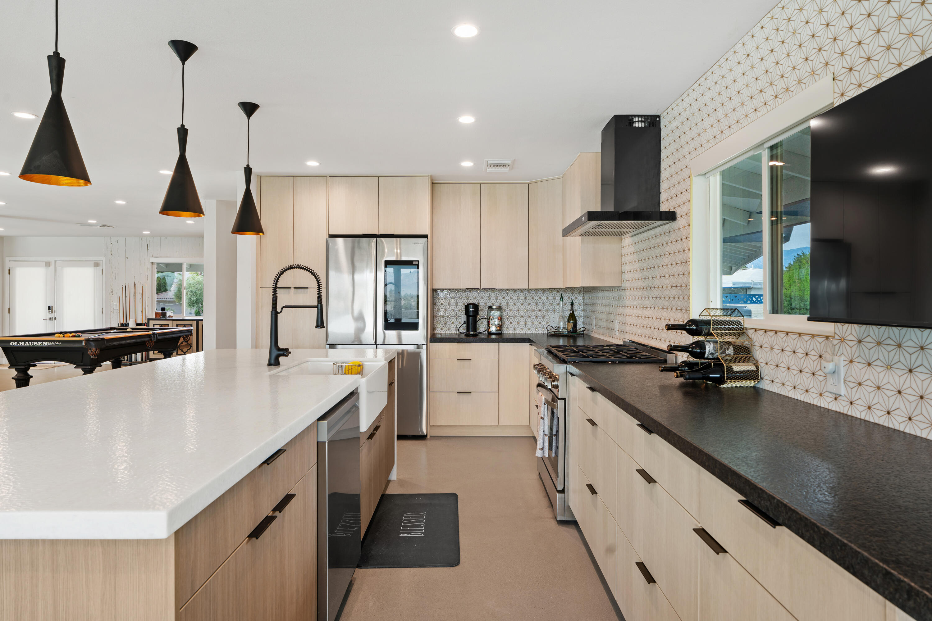 43490 Bath Point Court Bermuda Dunes, CA 92203 - Photo 14 of 38 a kitchen with white cabinets a sink a stove and a wooden floors