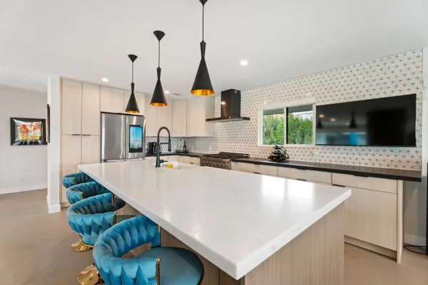 a kitchen with stainless steel appliances a sink a counter top space cabinets and a wooden floor