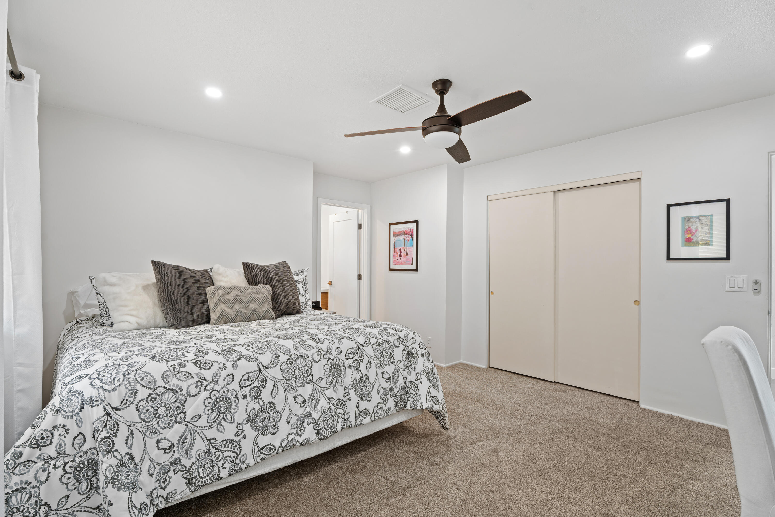 43490 Bath Point Court Bermuda Dunes, CA 92203 - Photo 18 of 38 a bedroom with a large bed and a chandelier