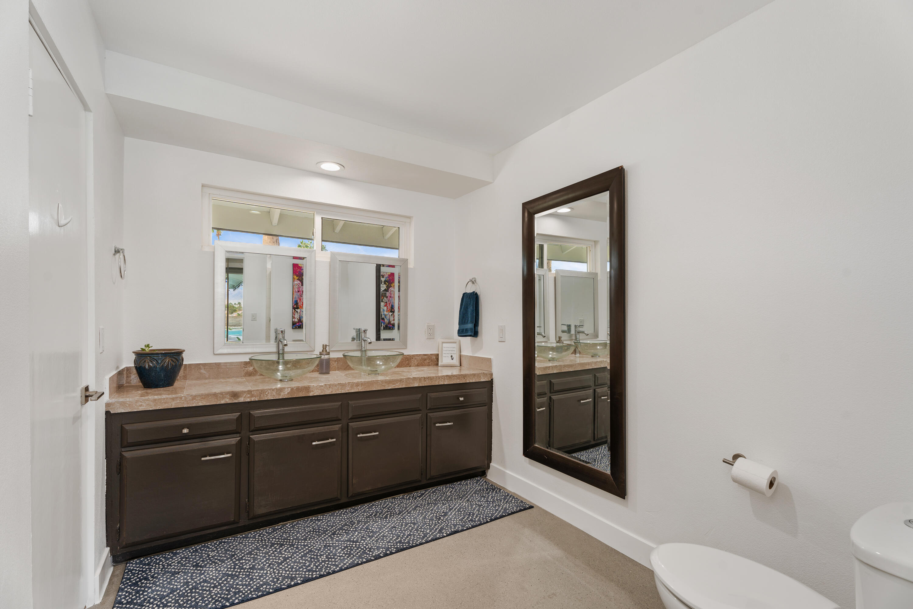 43490 Bath Point Court Bermuda Dunes, CA 92203 - Photo 20 of 38 a spacious bathroom with a granite countertop sink mirror and toilet