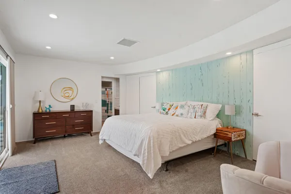 a bedroom with a bed and a dresser