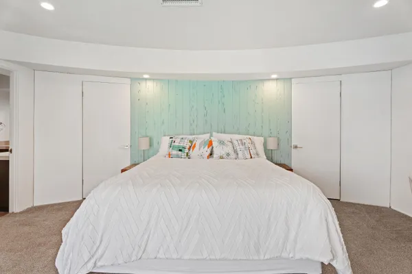 a large white bed in a white room