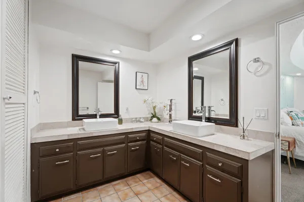 a bathroom with a granite countertop sink double and mirror