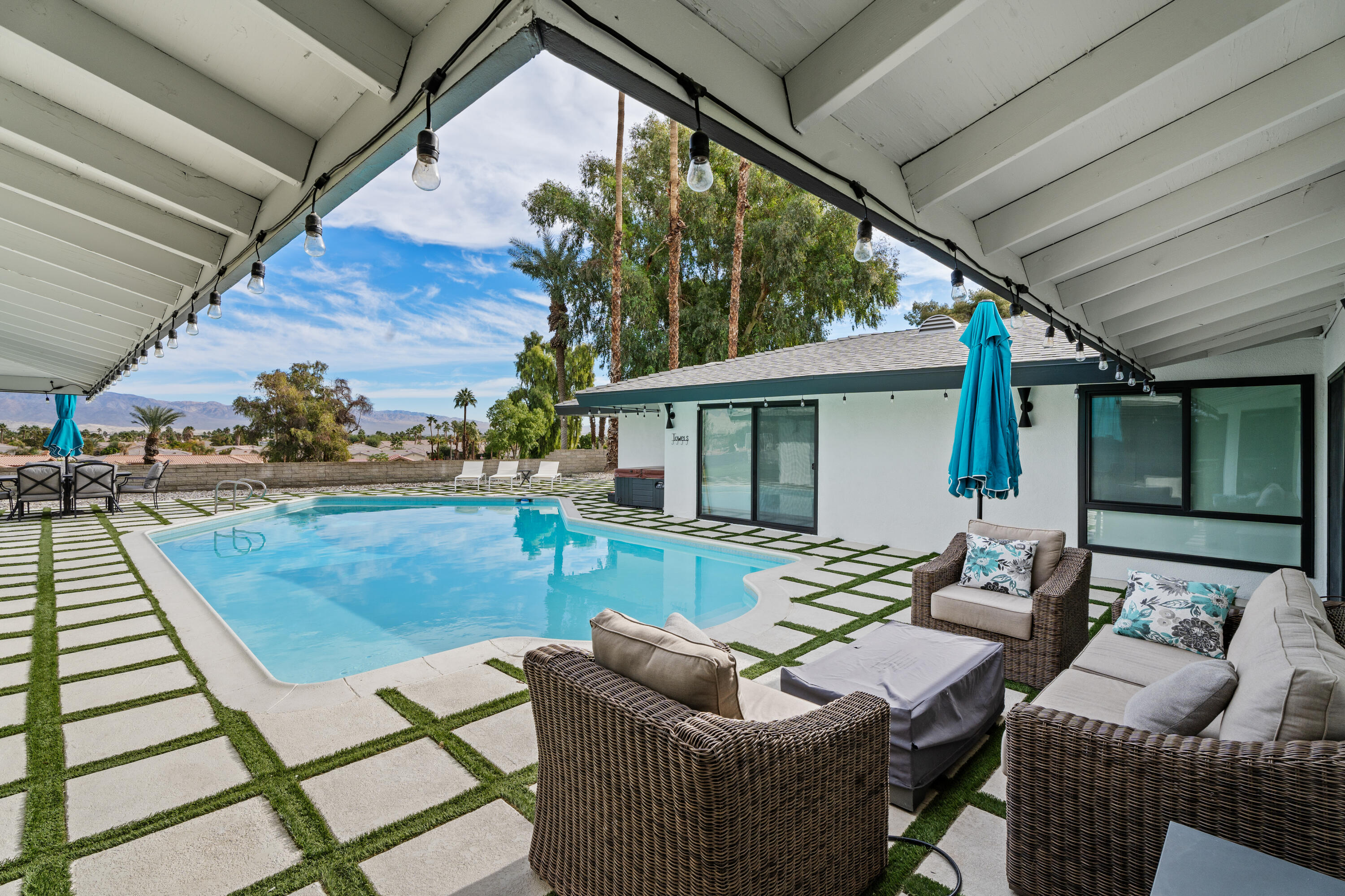 43490 Bath Point Court Bermuda Dunes, CA 92203 - Photo 32 of 38 a view of a patio with couches chairs and wooden floor