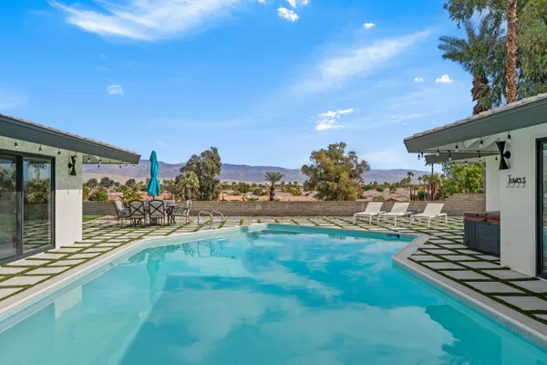 a view of a swimming pool with an outdoor seating