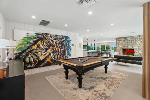 a living room with furniture gym equipment and a table