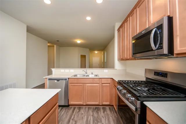 a kitchen that has a sink and a stove top oven