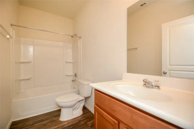 a bathroom with a bathtub and a toilet