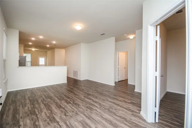 a view of an empty room and wooden floor