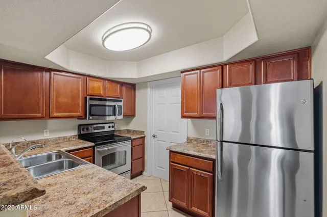 a kitchen with stainless steel appliances a refrigerator and a sink