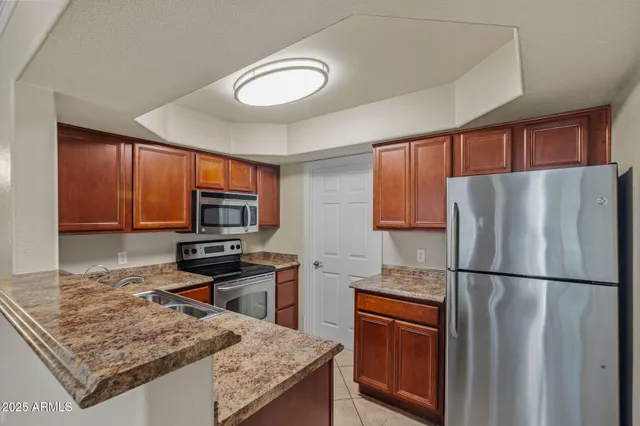 a kitchen with stainless steel appliances a refrigerator and a microwave